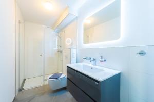 een badkamer met een wastafel en een toilet bij Ferienwohnung am Kleinbahnhof in Binz +28 foto's