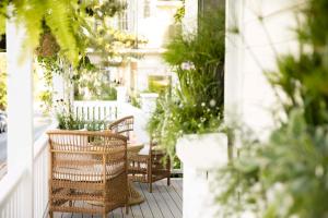 a porch with chairs and potted plants at Life House, Nantucket in Nantucket