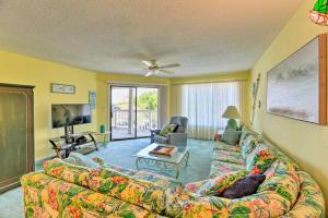 a living room with a couch and a tv at Point Emerald Resort Retreat Walk to Beach! in Emerald Isle