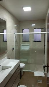 a bathroom with a glass shower and a toilet at Pousada Monte Carlo in São Joaquim +74 photos
