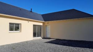 a white house with a black roof at Maison Neuve Moderne in Fresney-le-Vieux