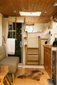 a bedroom with a bed and a shower in a room at Abbeyfield Horsebox Glamping in Morpeth