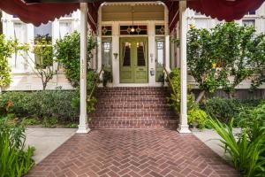 a house with a green door and stairs at Garden Street Inn Downtown San Luis Obispo, A Kirkwood Collection Hotel in San Luis Obispo