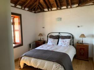 a bedroom with a bed with two pillows on it at Villa Awara by Rural La Palma in El Pinillo