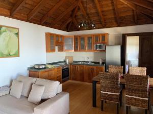 a kitchen with a couch and a table at Villa Awara by Rural La Palma in El Pinillo
