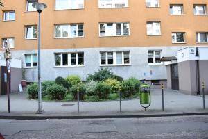 a street with a pay phone in front of a building at Rooms4Less in Gdańsk
