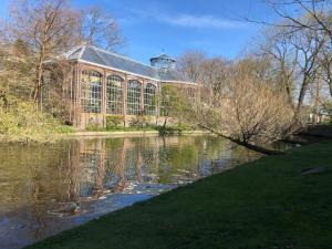 a building next to a body of water with a building at Hotel Hortus in Amsterdam