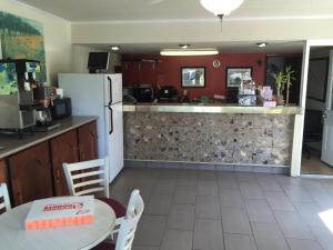 a kitchen with a counter and a table with a cake on a table at Kings Inn in Lenoir City