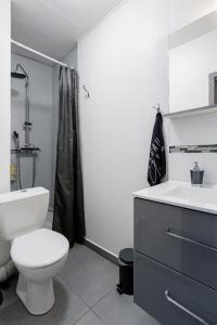 a bathroom with a white toilet and a sink at MyHome Basel RC44B in Saint-Louis