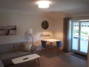 a living room with a couch and a table at Ferienwohnung 4 Familie Ramm in Eutin