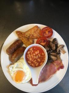 a plate of breakfast food with eggs sausage beans and toast at Number14brighton in Brighton & Hove