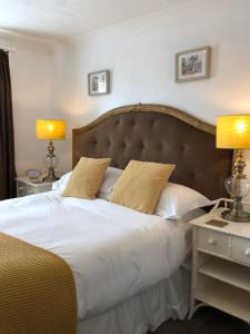 a bedroom with a large bed with two lamps at Number14brighton in Brighton & Hove