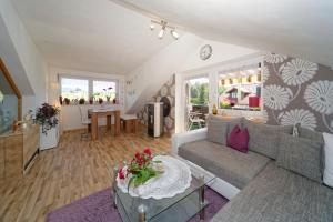 a living room with a couch and a table at Ferienwohnungen Claus in Frauenau