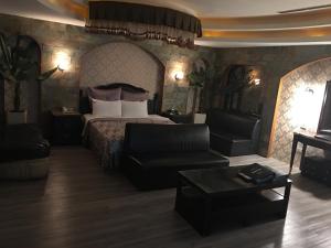 a bedroom with a bed and a couch and a table at Discovery Motel - Tucheng in Tucheng