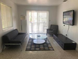 a living room with a couch and a coffee table at Explore Wynwood 2bedrooms and free parking in Miami