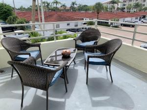 a group of chairs and a table on a balcony at Island House Beach Resort 4S in Point O'Rocks