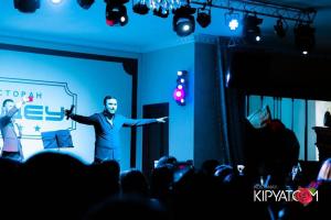 a man standing on a stage in front of a crowd at Medeu in Kostanay