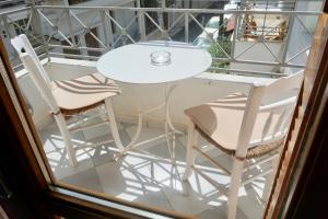 a table and two chairs sitting next to a window at Crete Garden Apartments in Agios Nikolaos