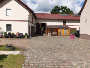 a house with a brick patio in front of it at MyRooms in Schönfließ