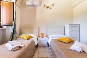 Posteľ alebo postele v izbe v ubytovaní Villa Ajeni by Perle di Puglia