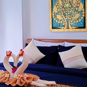 a bed with two swans made out of towels at Orange palm pool villa in Chaweng +24 photos