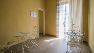 a room with two tables and chairs and a window at Royal Dante in Naples