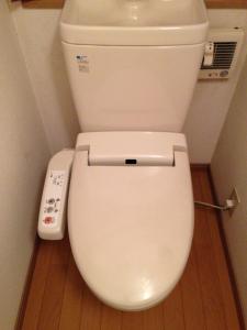 a bathroom with a toilet with a remote control at 民泊Ｒｉｋａ in Tokai