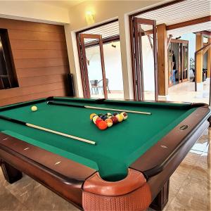a pool table with cue balls on top of it at Orange palm pool villa in Koh Samui 