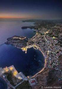an aerial view of a city and the ocean at night at Afrodite Hotel Apartments in Myrina