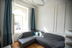 a living room with a couch and a window at Live with a fantastic view in the city center in Prague