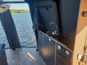 a kitchen on the back of a boat on the water at Koivuranta Igloos in Oulu