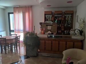a kitchen and dining room with a bar and a table at Hotel Luana in Chianciano Terme