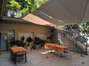 a patio with two tables and chairs and a staircase at Hotel Luana in Chianciano Terme