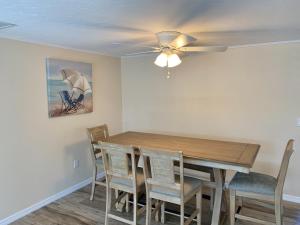 a dining room with a wooden table and chairs at Island House Beach Resort 7 in Siesta Key
