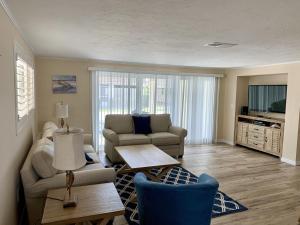 a living room with a couch and a table at Island House Beach Resort 7 in Siesta Key