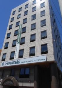 a building with a sign on the front of it at Terminal Hotel Matsuyama in Matsuyama