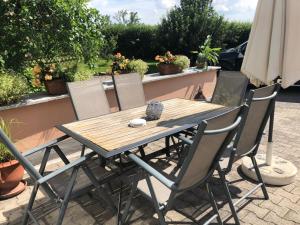 a wooden table and chairs on a patio at Pension Sigle in Dingolfing