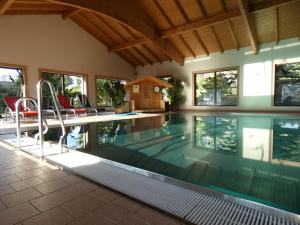 a swimming pool in a house at Hotel-Pension Flechsig in Hartmannsdorf