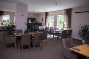 a dining room with wooden tables and chairs at Waldidyll Rabenhorst in Homburg