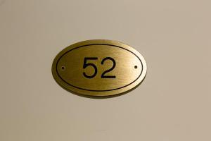 a gold button with the number on a wall at Hotel Marina in Monterosso al Mare