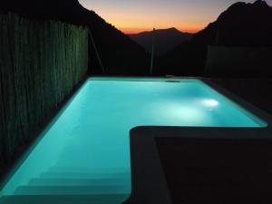 a swimming pool with a sunset in the background at La Atalaya in Benaocaz