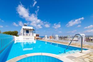 a swimming pool on the roof of a building at Okirroi Villas Chersonissos in Hersonissos