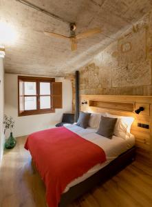 a bedroom with a large bed with a red blanket at ERASMUS PLAZA in Salamanca