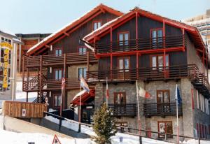 a large building with flags in front of it at Hotel Biancaneve in Sestriere