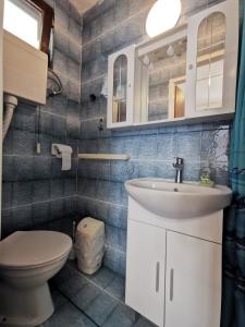 a bathroom with a sink and a toilet at Studio Bobo in Rovinj