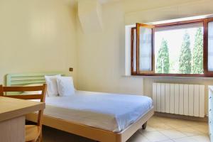Llit o llits en una habitació de Casa GINESTRA a Bagno Vignoni