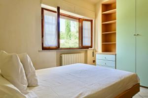 Llit o llits en una habitació de Casa GINESTRA a Bagno Vignoni