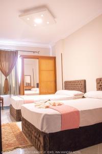 Jewel Mandara Apartments tesisinde bir odada yatak veya yataklar