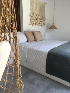 a bedroom with a bed with a net at AELLIA HOTEL & SUITES LEROS in Lakkíon