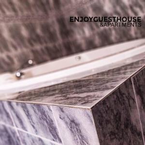 a close up of a marble counter top in a bathroom at Enjoy Guest House GMR in Guimarães